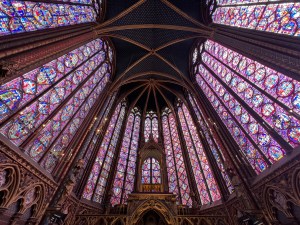 Interior view of Sainte Chapelle in Paris, showcasing its stunning stained glass windows and Gothic architecture, highlighting its importance as a sacred site.