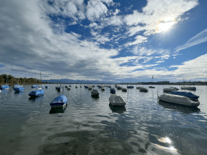 Calm Greifensee Lake with several still boats, symbolizing serenity and inner stillness.