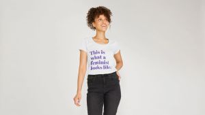 Woman wearing a Gaia's Threads T-shirt that reads 'This is what a feminist looks like,' symbolizing the celebration of the divine feminine and feminism.