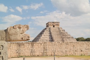 View of El Castillo pyramid at Chichen Itza in Mexico, surrounded by other ancient Mayan structures, highlighting its significance as a sacred site and marvel of Mayan civilization.