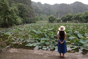 Person looking at a lily pond in Vietnam, reflecting on the connection with Mother Earth.
